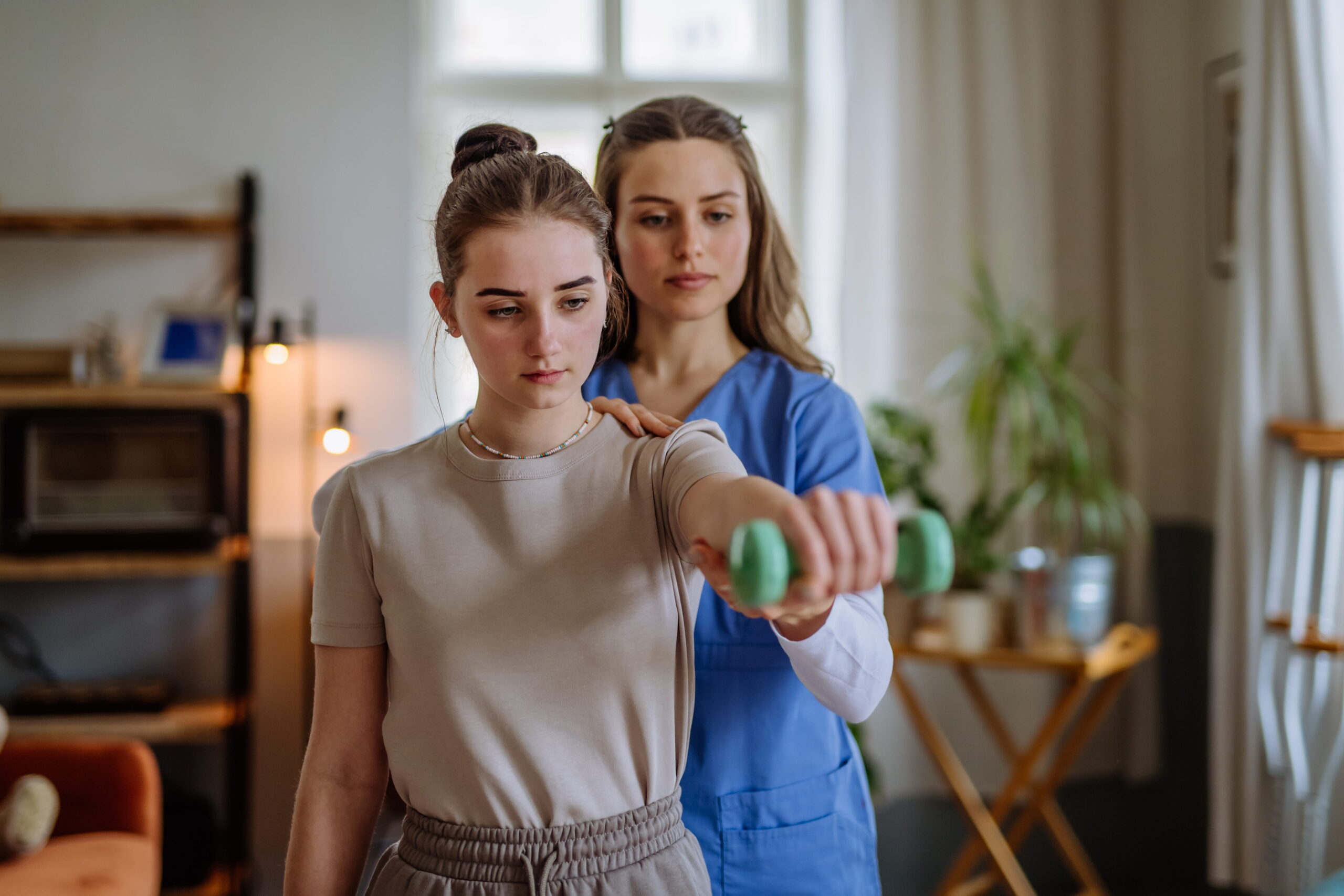 A physiotherapist treating a patient's shoulder in a Toronto clinic