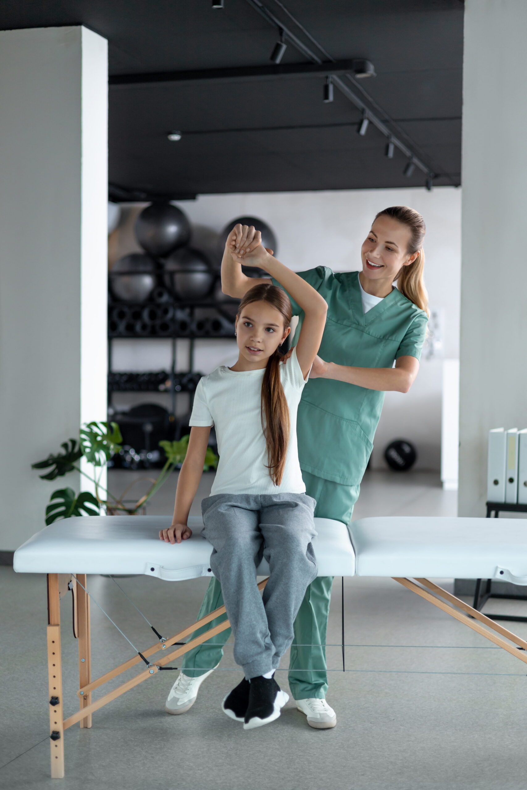 A physiotherapist treating a patient's shoulder in an Ottawa clinic