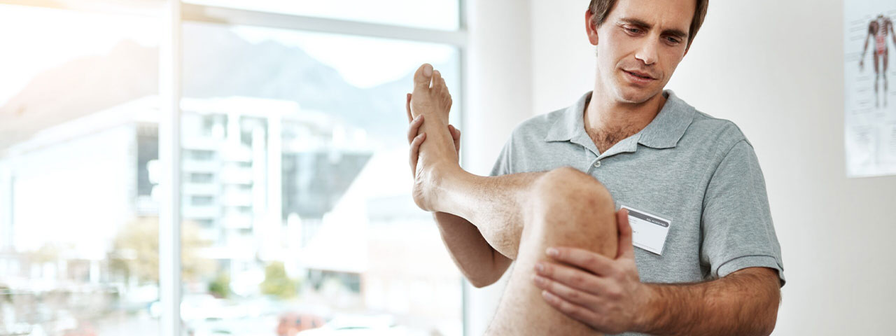 A physiotherapist treating a patient's shoulder in a Winnipeg clinic